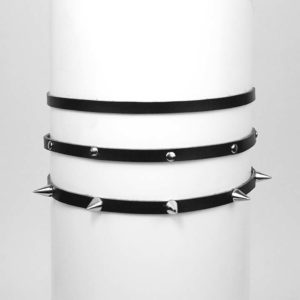 Three thin black chokers. One is plain, one has flat studs and the last has spikes.
