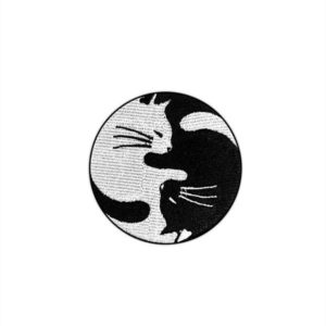 Yin Yang Cats Patch. iron on embroidery patch of two illustrated cats cuddling to resemble a yin yang symbol.