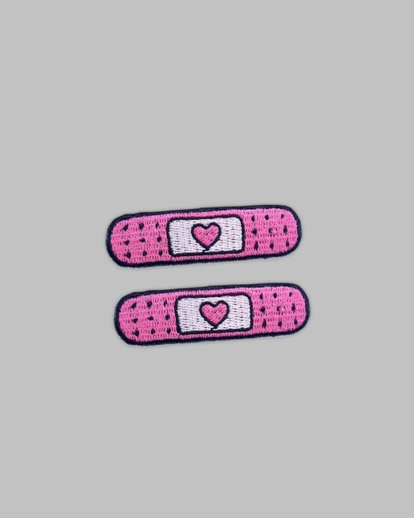 two pink bandage embroidered patches.